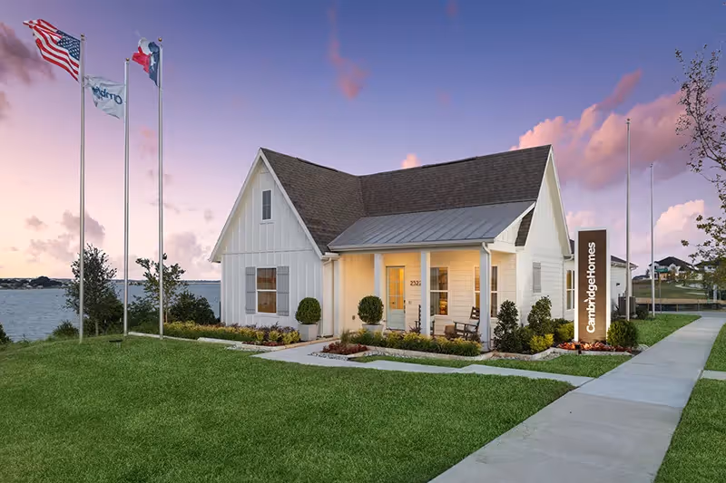 Outside photo of the lake park birchwood model, white siding with grassy lawn and landscaping