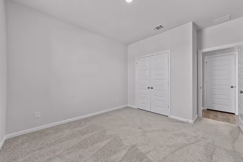 carpeted bedroom with closet