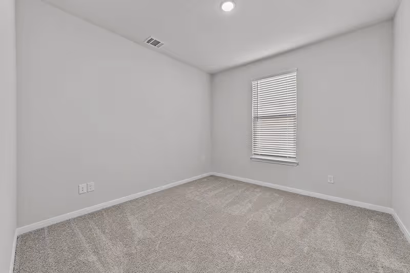 bedroom with carpet and window