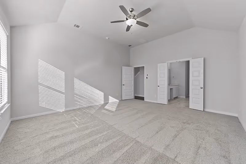 owners bedroom with double doors into bathroom