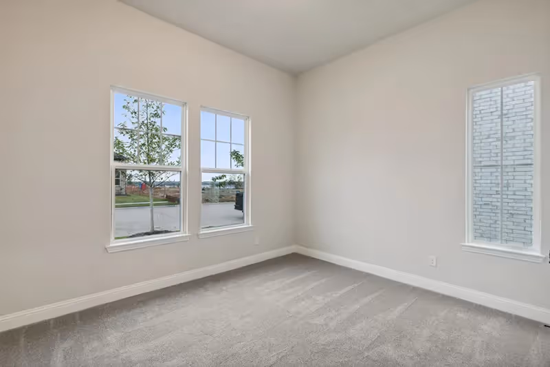 bedroom with carpet and windows