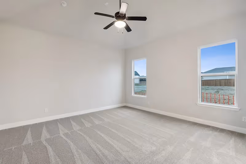 owners bedroom with carpet and windows