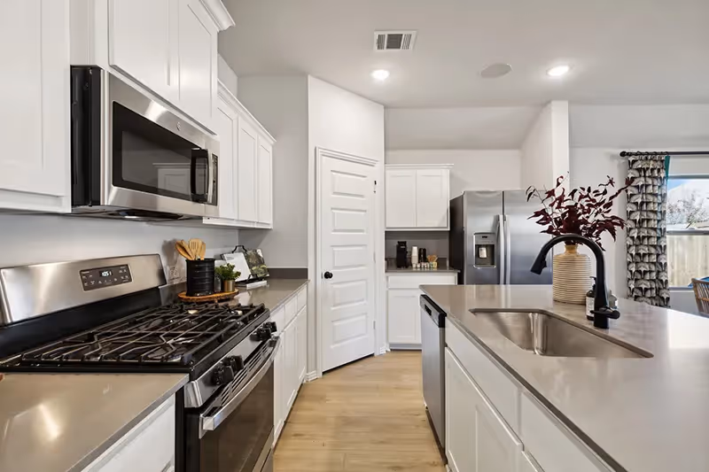 kitchen with pantry, kitchen island and microwave