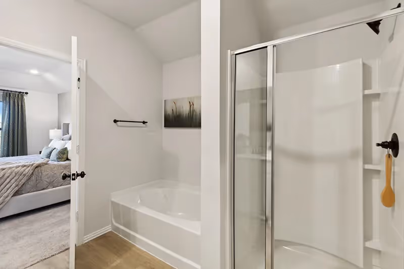 owners bathroom with tub and walk in shower