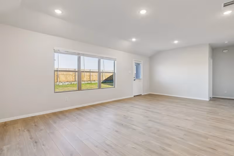 living roomliving room with windows and door to backyard