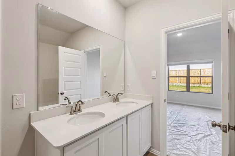 owners bathroom with dual sinks