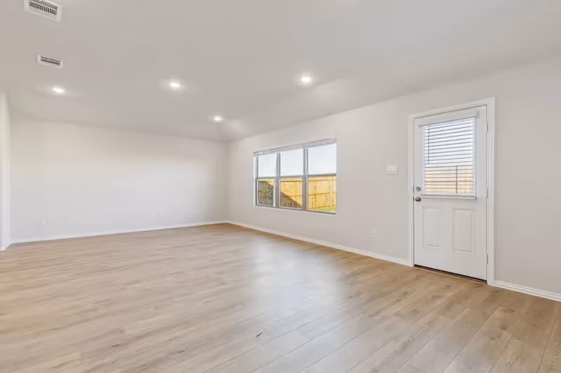 living room with windows and door to backyard