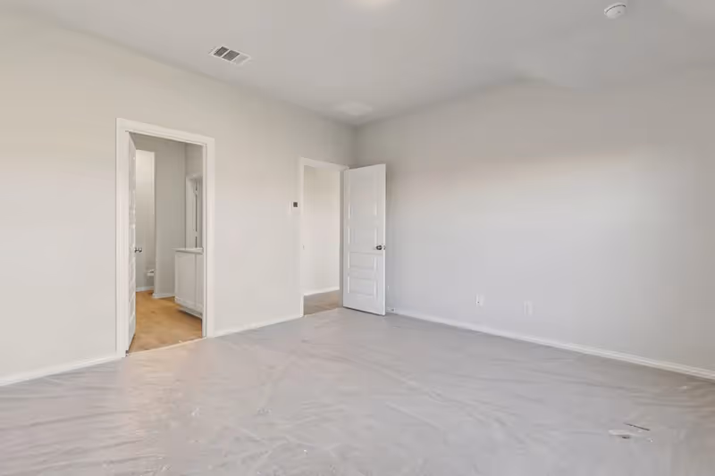 owners suite with door into bathroom