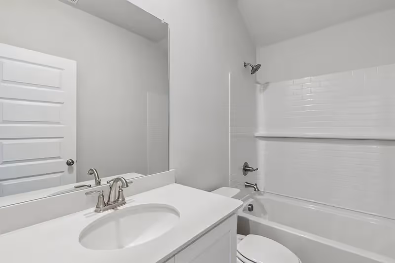 bathroom with white tile and tub