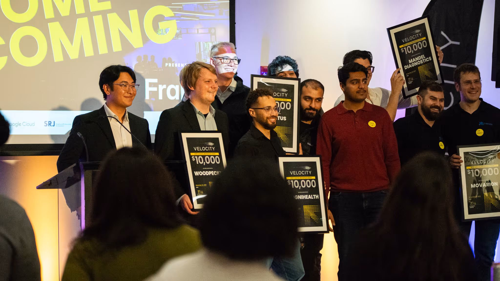 2025 Momentum Grant winners pose for group photo on stage at Velocity Homecoming