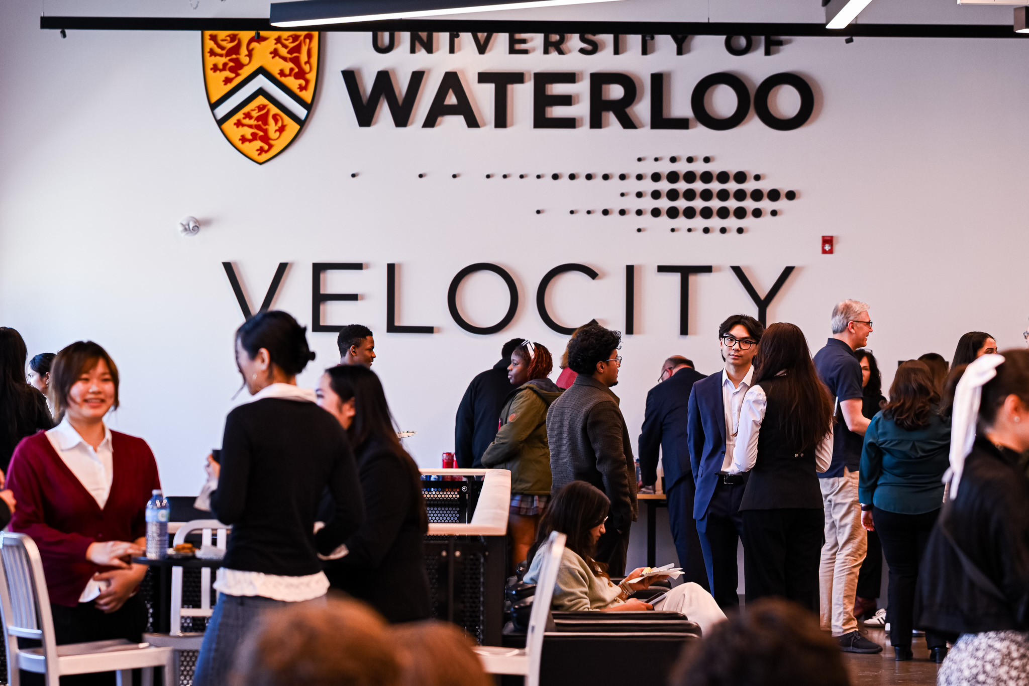 A group of students and founders chatting together inside the Velocity Innovation Arena