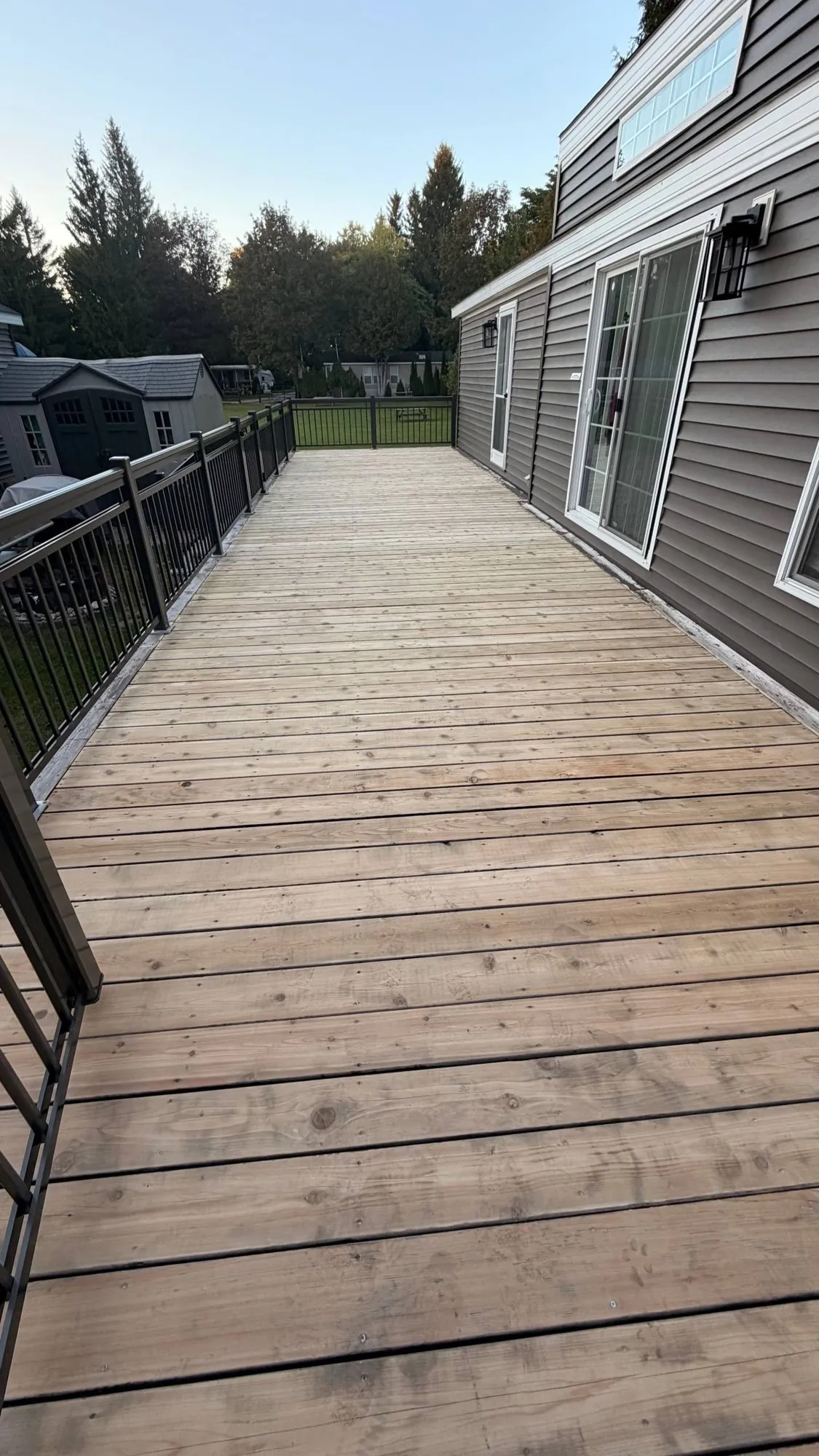 Deck Refinishing in Whitchurch-Stouffville: Long Pressure-Treated Deck Sanded and Restained with an Oil-Based Stain