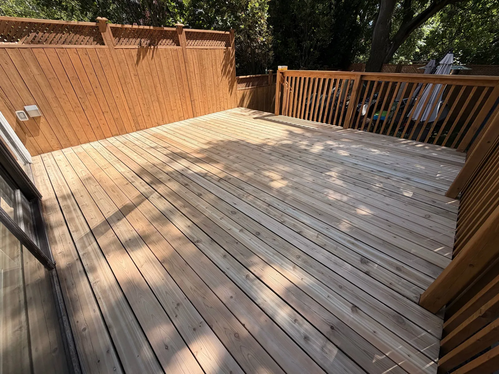Cedar Deck Restoration in Toronto: Rotted Boards Replaced, Deck and Privacy Screen Sanded and Stained in C2 Guard Ponderosa