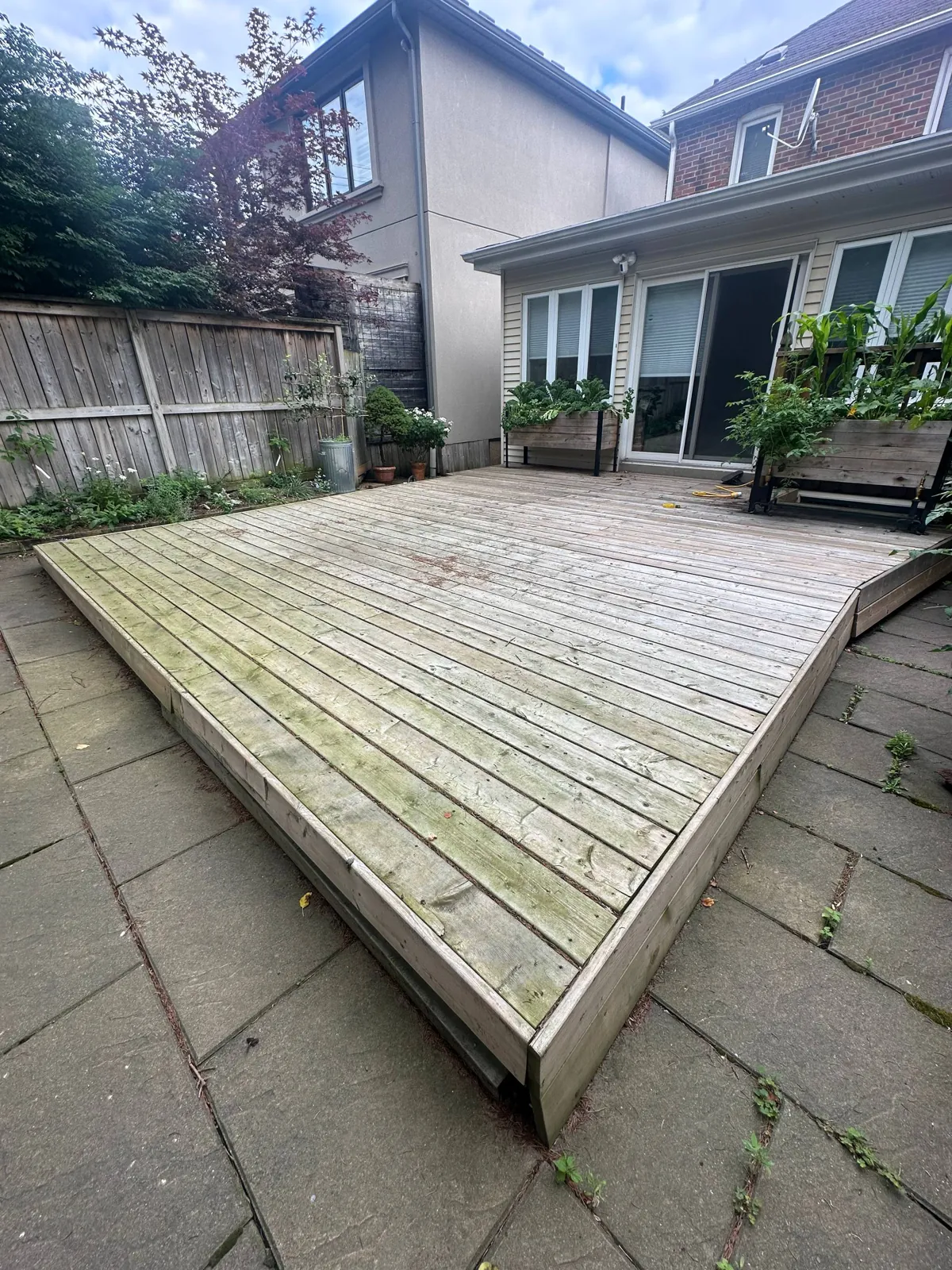 Grey Platform Deck Restored in Toronto: Weathered Pressure-Treated Deck Sanded to Bare Wood and Stained with a Penetrating Oil