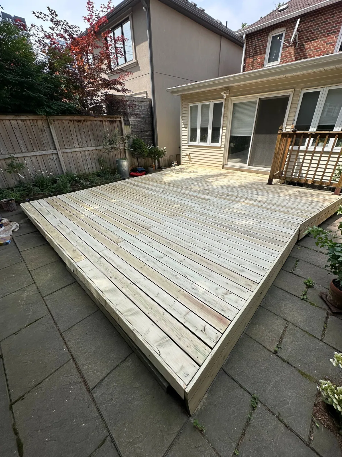 Grey Platform Deck Restored in Toronto: Weathered Pressure-Treated Deck Sanded to Bare Wood and Stained with a Penetrating Oil