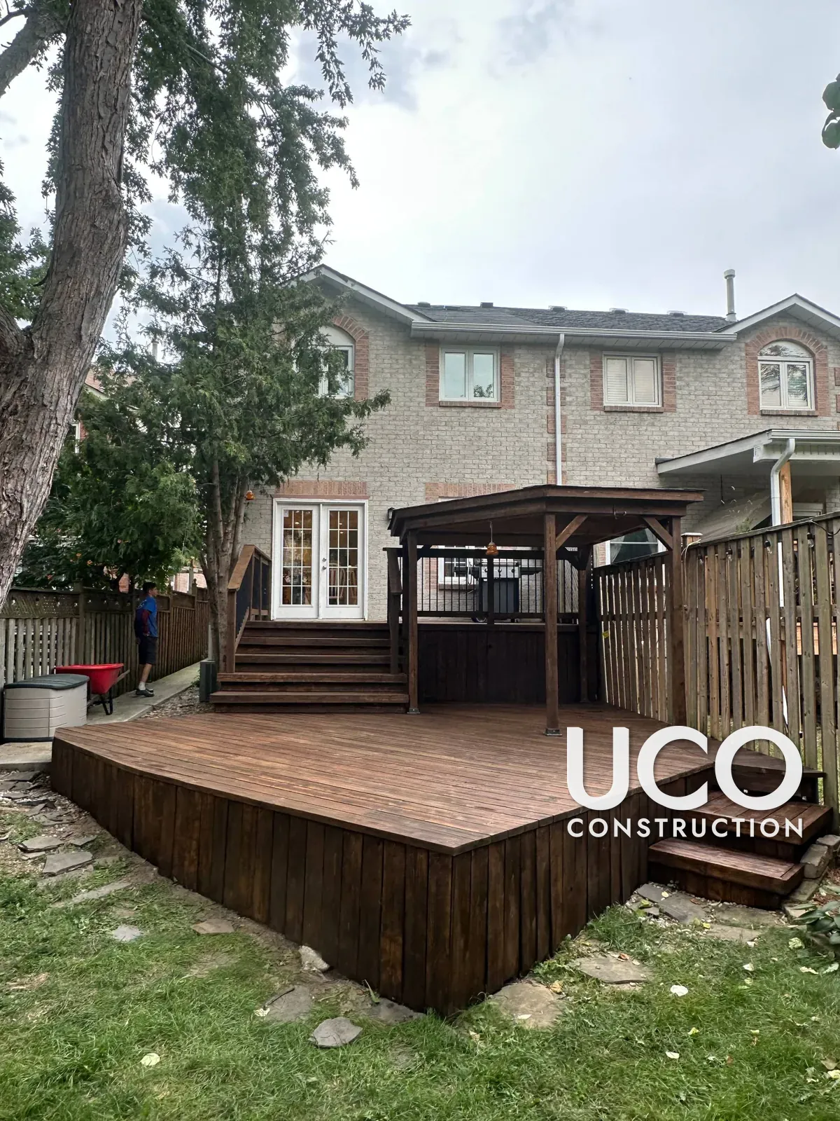 Deck Restoration in Mississauga: Grey Weathered Multi-Level Deck, Stairs, Railings, Pergola and Skirting Sanded to Bare Wood and Refinished in a Dark Brown Oil-Based Stain