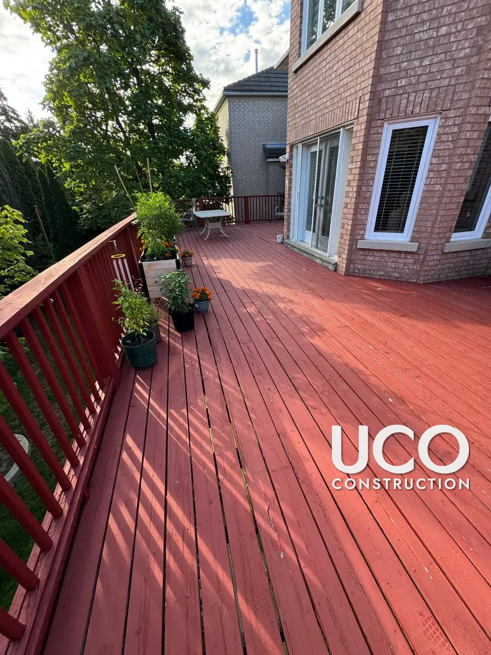 Deck Colour Change in Mississauga: Faded Red Solid Stain Removed, Floor Refinished in a Dark Walnut Oil-Based Stain and Railings Painted Cream With Stained Caps