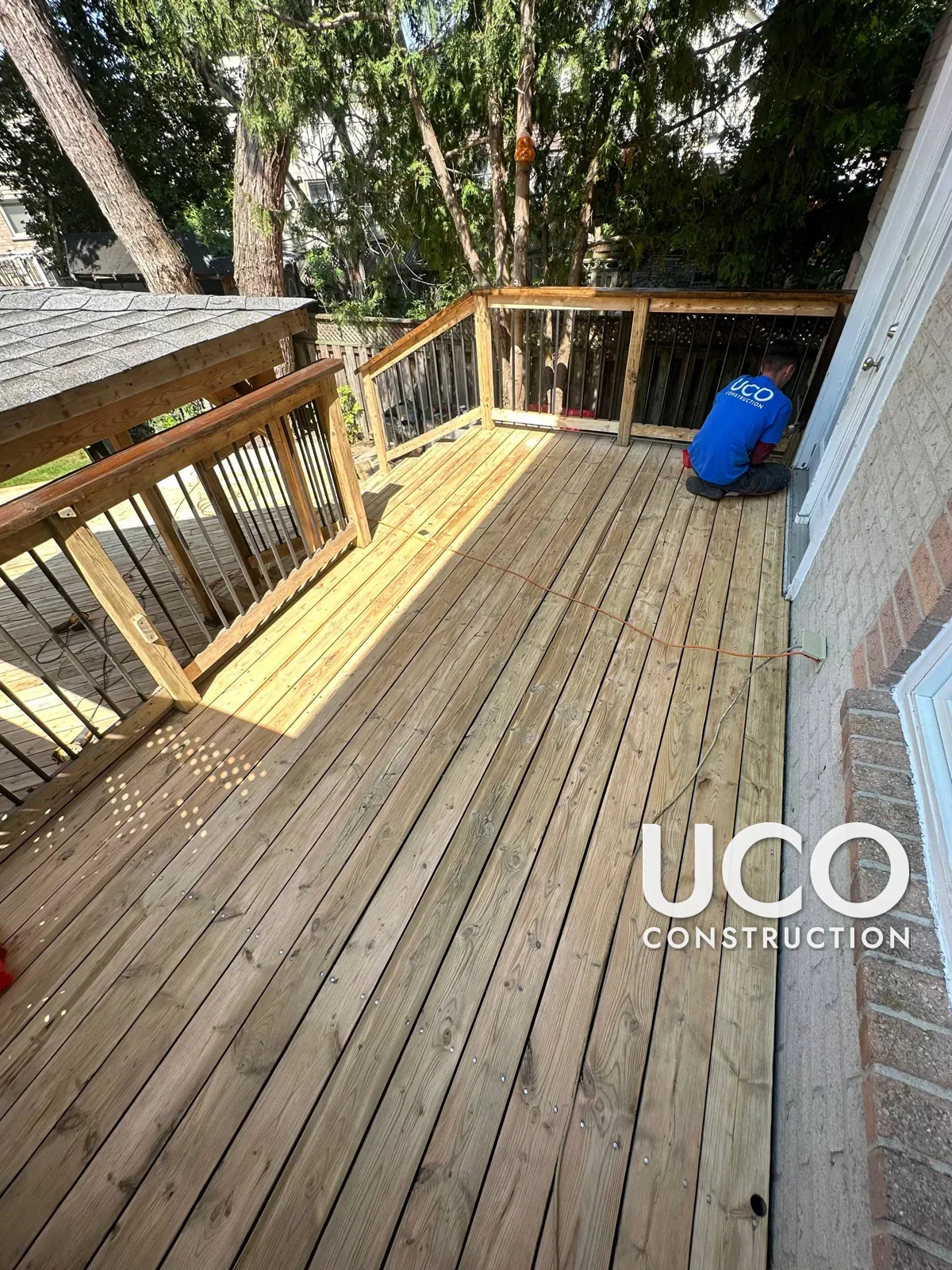 Deck Restoration in Mississauga: Grey Weathered Multi-Level Deck, Stairs, Railings, Pergola and Skirting Sanded to Bare Wood and Refinished in a Dark Brown Oil-Based Stain
