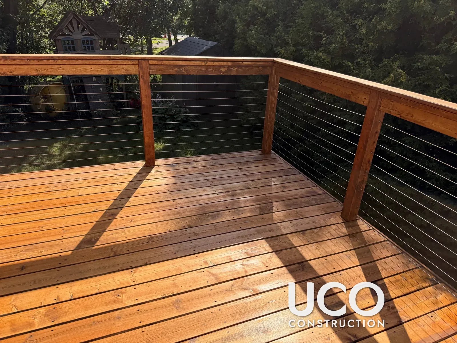 Deck Restoration in Oshawa: Grey Cedar Deck with Cable Railings Sanded to Bare Wood, One Board Replaced and Finished with Oil-Based Stain