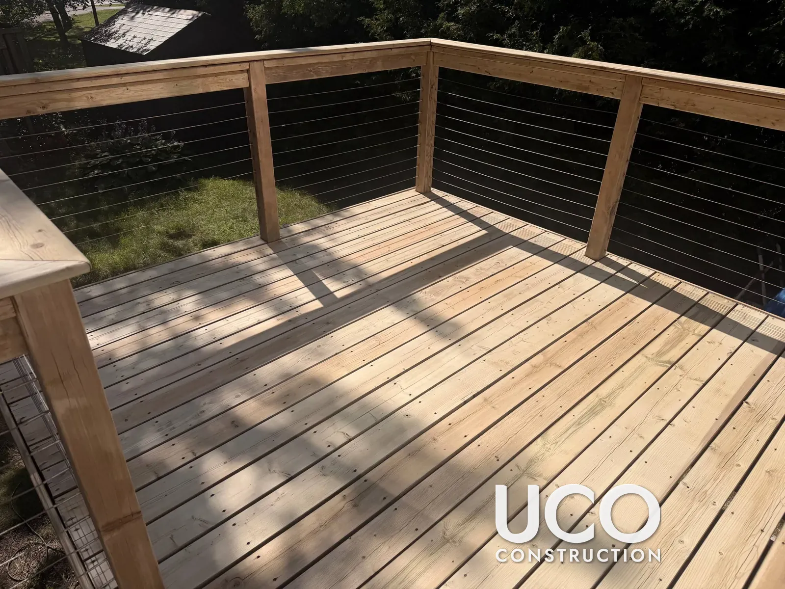 Deck Restoration in Oshawa: Grey Cedar Deck with Cable Railings Sanded to Bare Wood, One Board Replaced and Finished with Oil-Based Stain