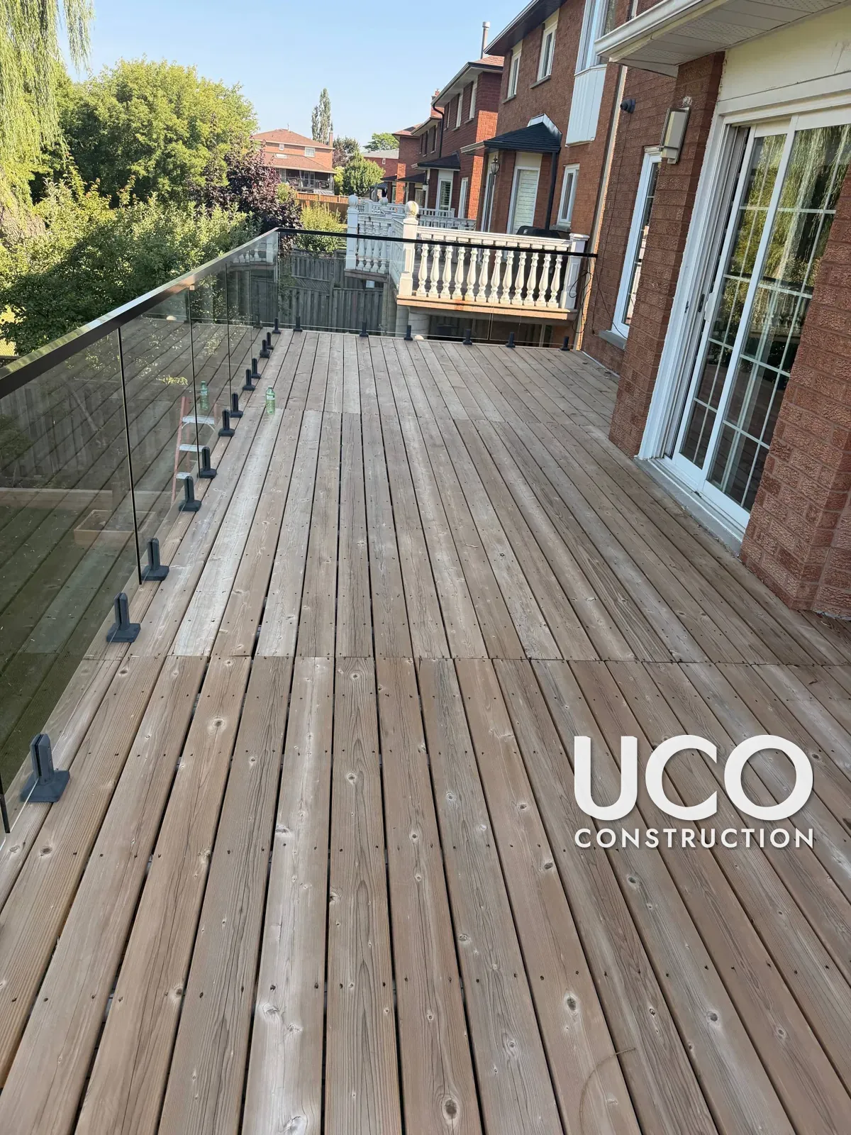 First Stain on a One-Year-Old Cedar Deck in Vaughan: New Deck with Glass Railings Sanded and Finished Before It Greyed