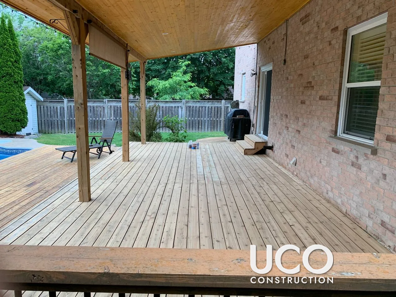 Covered Deck Restoration in Richmond Hill: Two-Level Pool Deck With Roof Sanded to Bare Wood and Refinished in a Warm Cedar Oil-Based Stain
