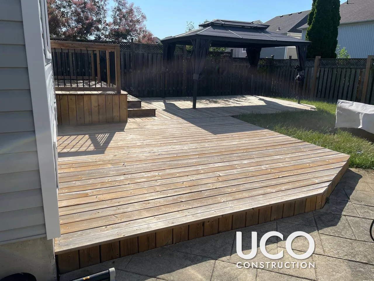 New Deck First Stain in Oshawa: One-Year-Old Multi-Level Pressure-Treated Deck Prepped and Stained for the First Time in a Brown Semi-Transparent Stain