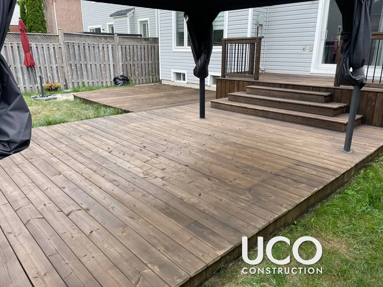 New Deck First Stain in Oshawa: One-Year-Old Multi-Level Pressure-Treated Deck Prepped and Stained for the First Time in a Brown Semi-Transparent Stain