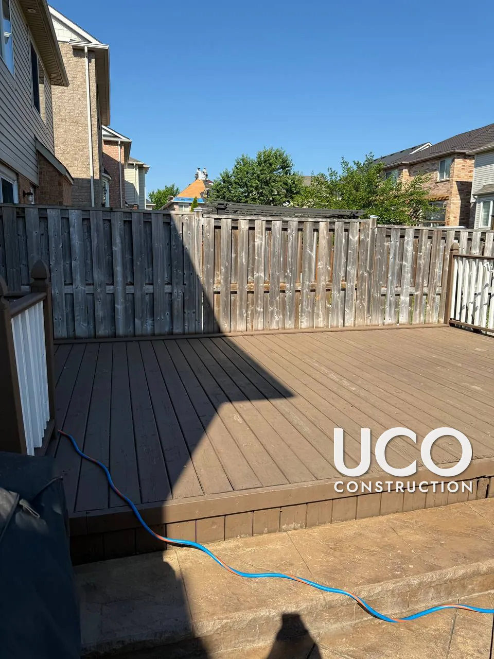 Deck and Fence Staining in Brampton: Faded Brown Deck and Grey Privacy Fence Sanded to Bare Wood and Refinished Together in a Warm Oil-Based Stain, Railings Restained Brown