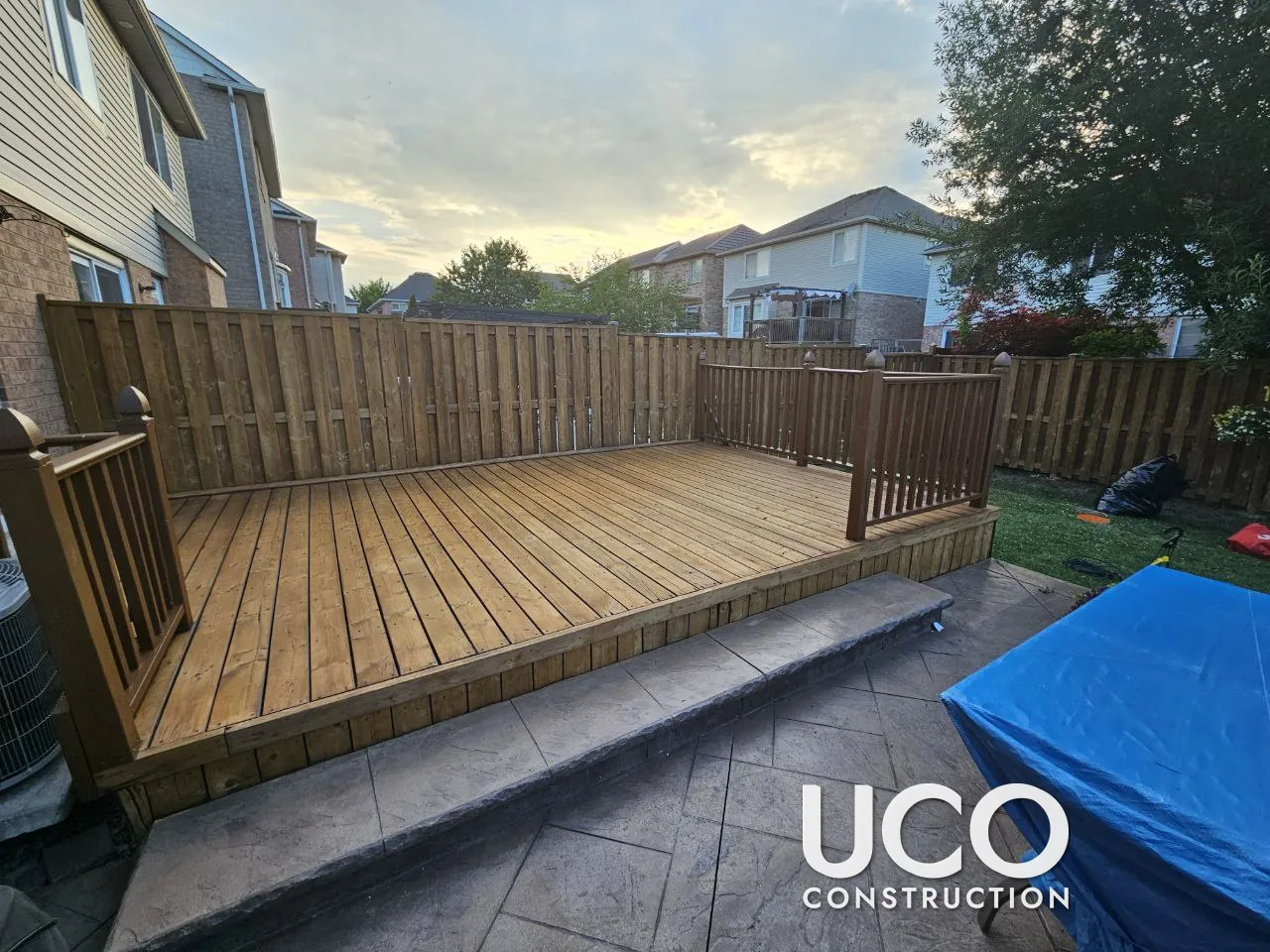 Deck and Fence Staining in Brampton: Faded Brown Deck and Grey Privacy Fence Sanded to Bare Wood and Refinished Together in a Warm Oil-Based Stain, Railings Restained Brown