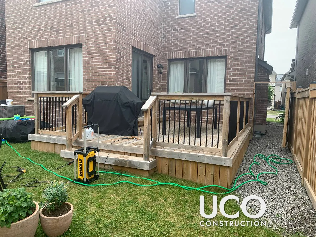 Deck Staining in Oakville: Weathered Grey Deck, Stairs, Railings and Skirting Power Washed, Sanded and Refinished in a Warm Oil-Based Stain