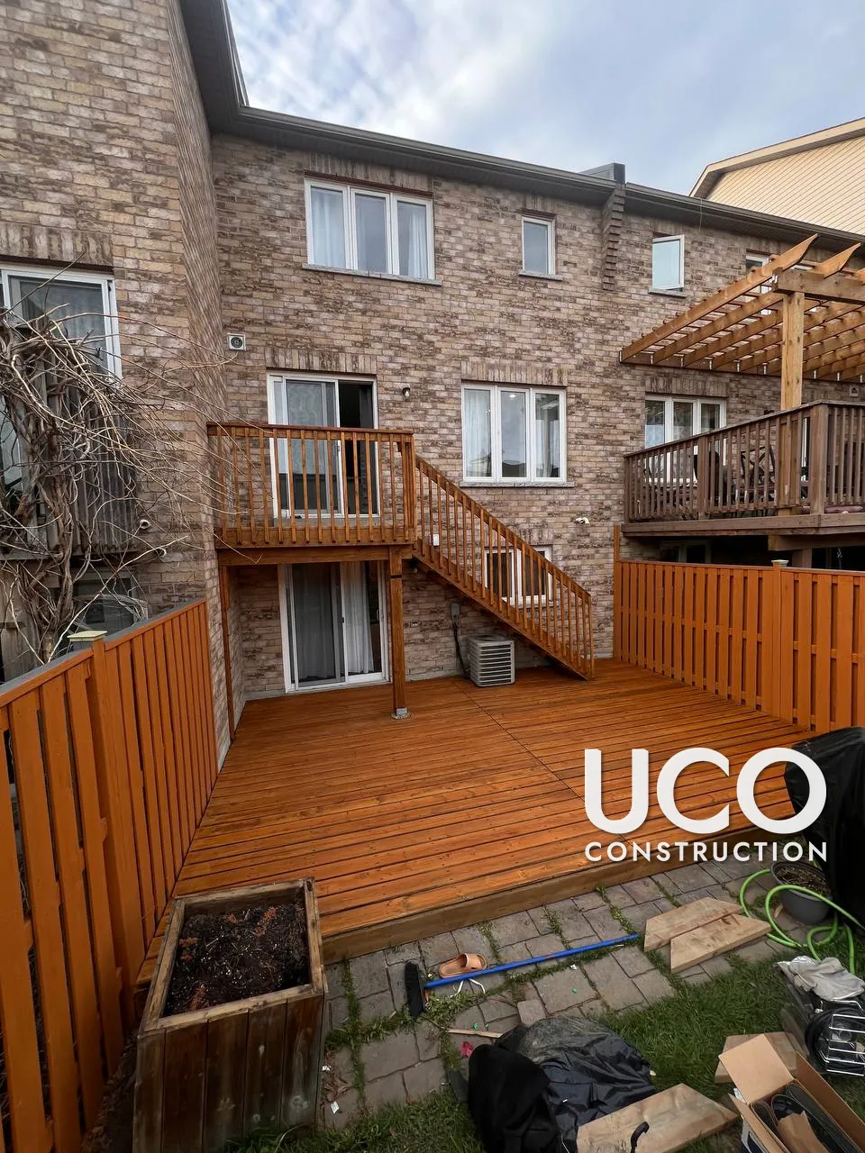 Deck Staining in Ajax: Dark, Peeling Deck Stain Sanded Off to Bare Wood and Refinished in a Warm Cedar Oil-Based Stain