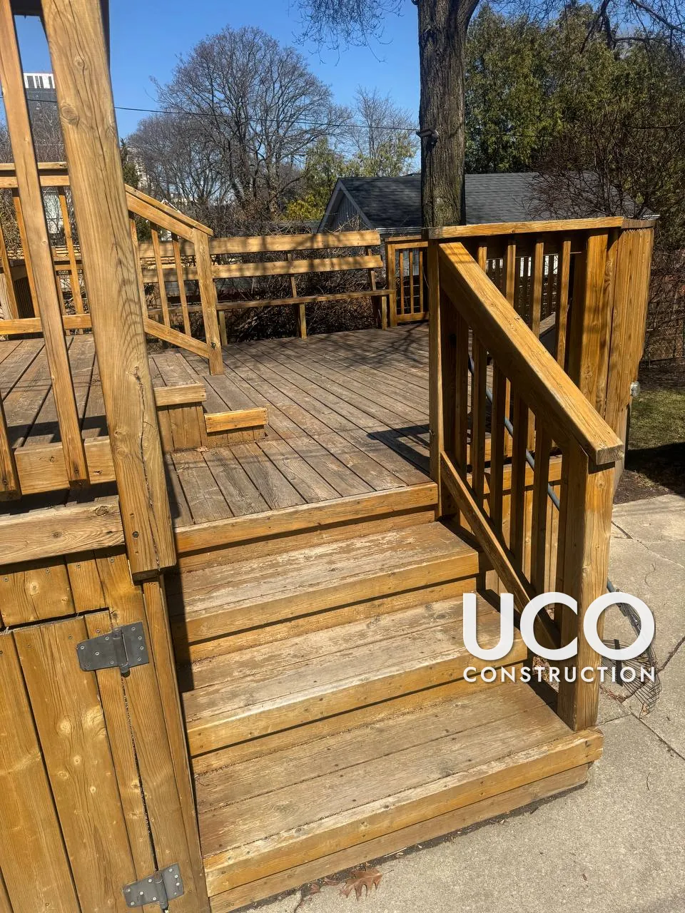 Deck Staining in Toronto: Faded Two-Level Deck With Built-In Bench, Railings and Stairs Sanded and Restained in a Warm Cedar Tone