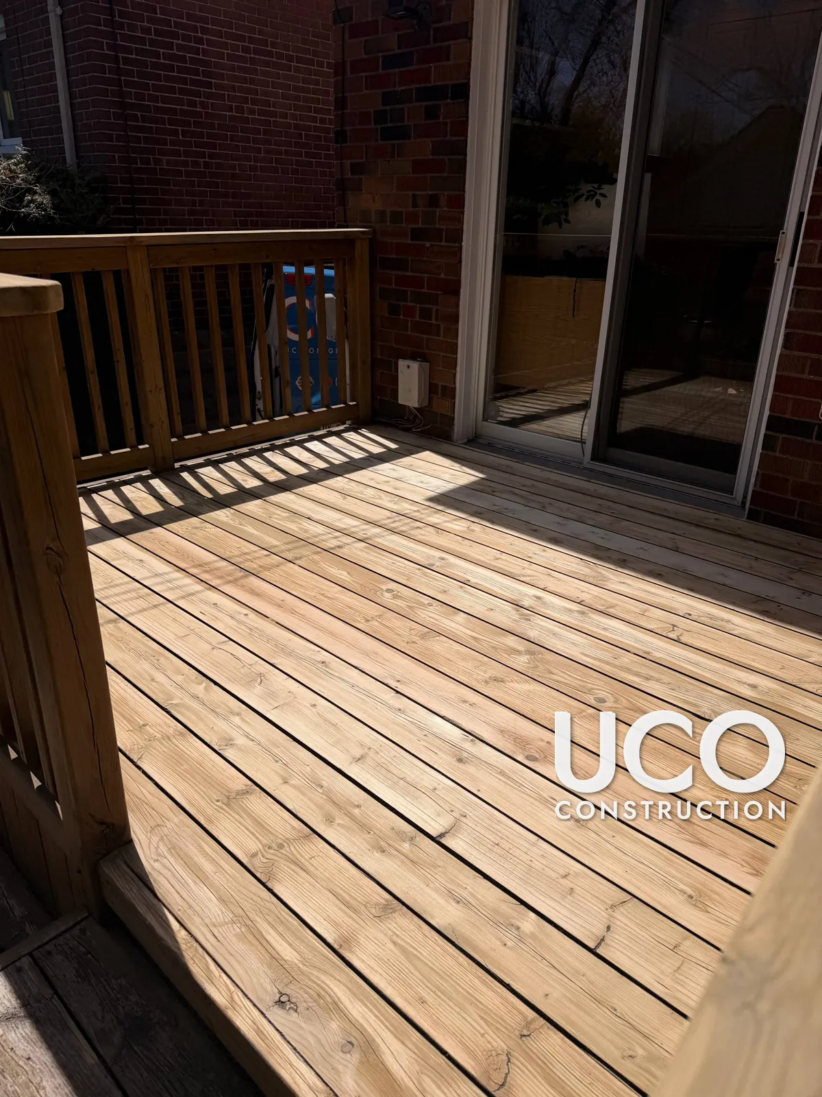 Deck Staining in Toronto: Faded Two-Level Deck With Built-In Bench, Railings and Stairs Sanded and Restained in a Warm Cedar Tone