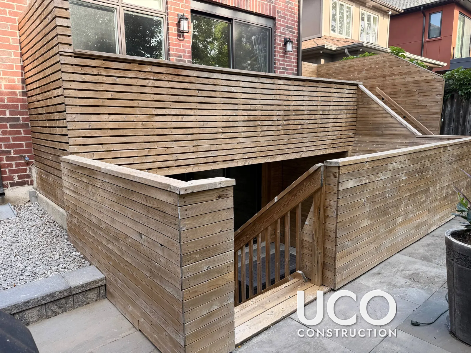 Deck Staining in East York: Modern Horizontal Slat Deck Walls, Privacy Screens and Walkout Stairwell Cleaned, Sanded and Stained in a Warm Cedar Tone