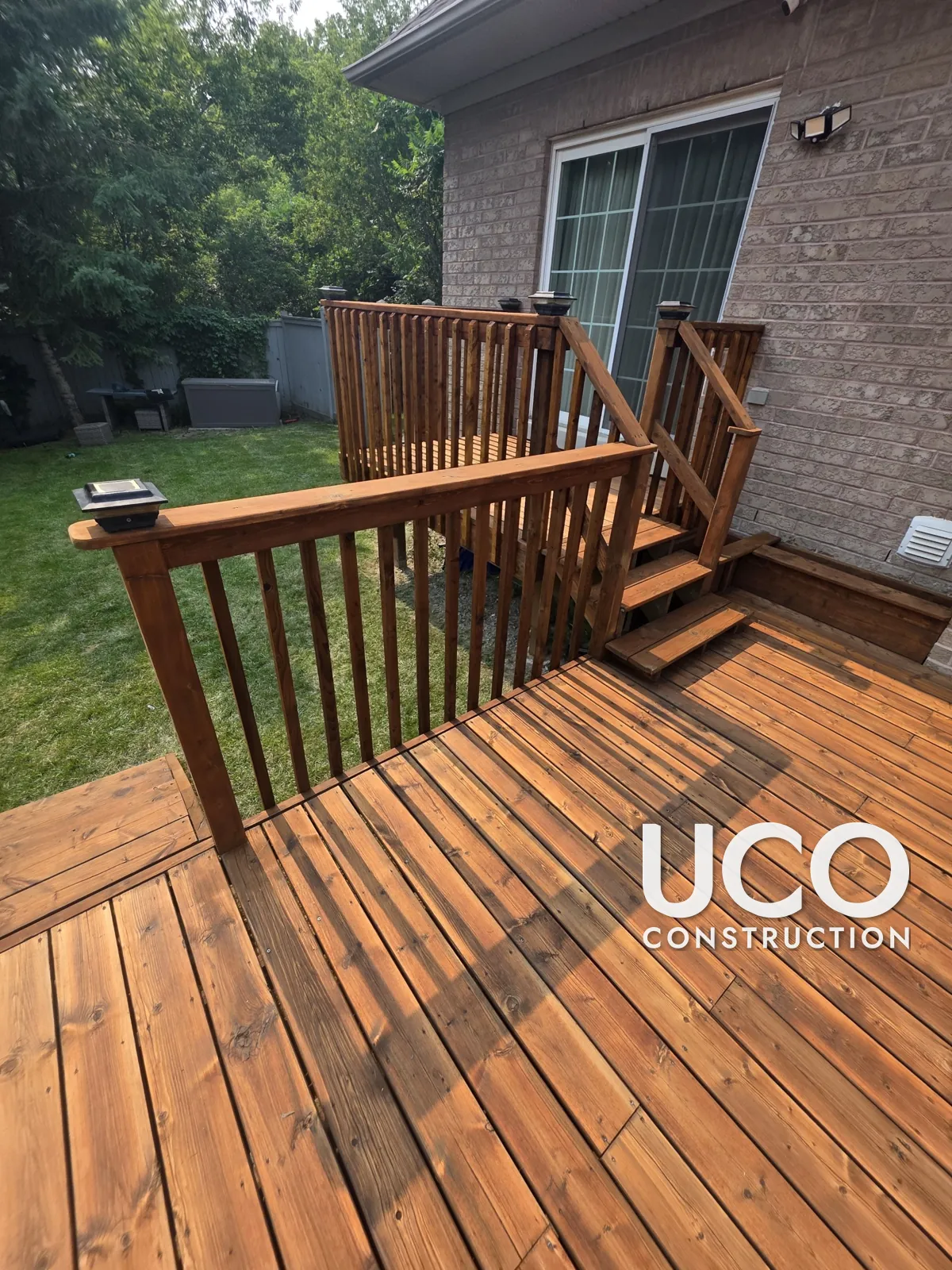 Deck Staining in Ajax: Two-Level Deck With Peeling Red-Brown Solid Stain Sanded to Bare Wood and Refinished in a Warm Cedar Stain