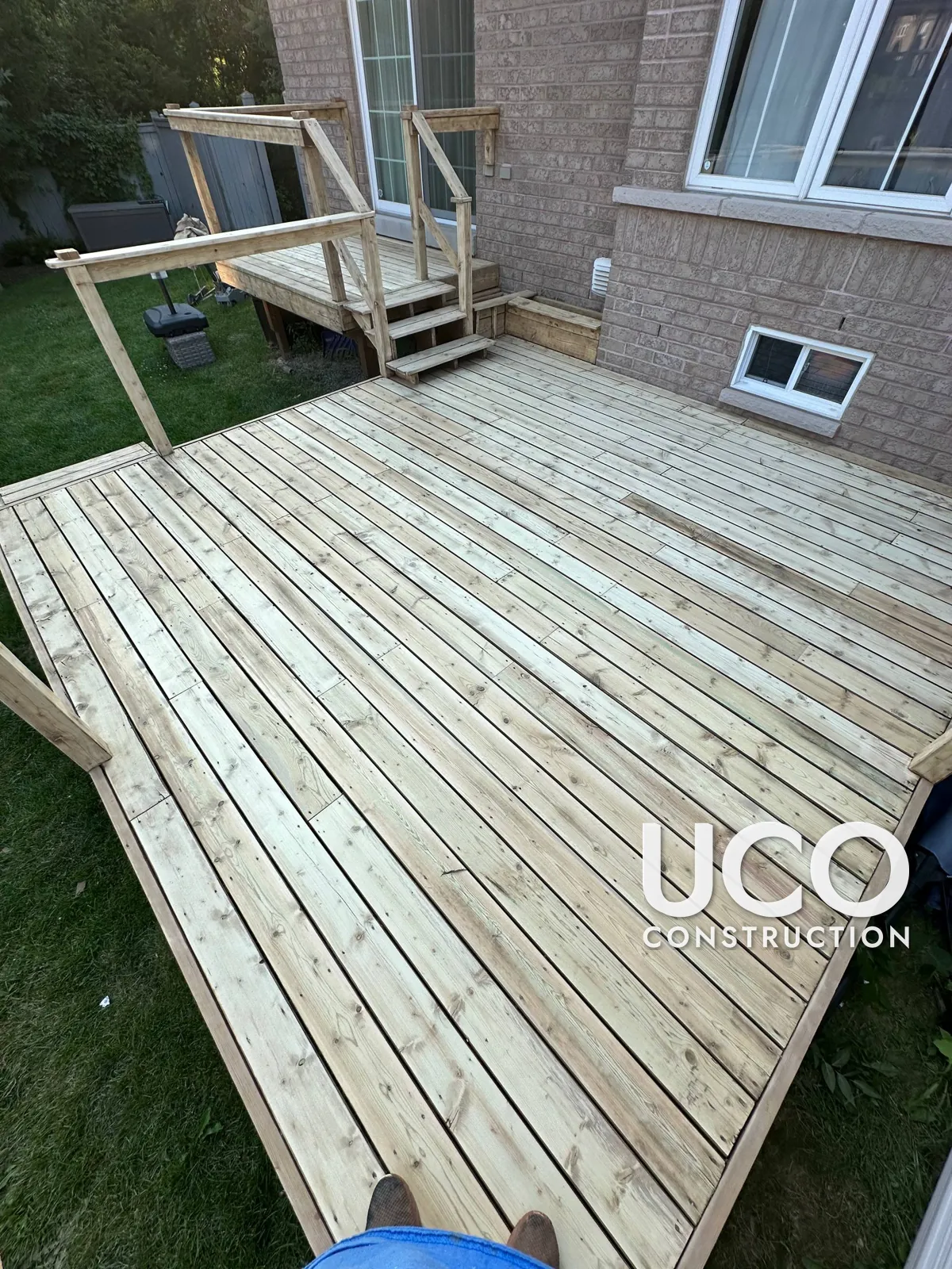 Deck Staining in Ajax: Two-Level Deck With Peeling Red-Brown Solid Stain Sanded to Bare Wood and Refinished in a Warm Cedar Stain