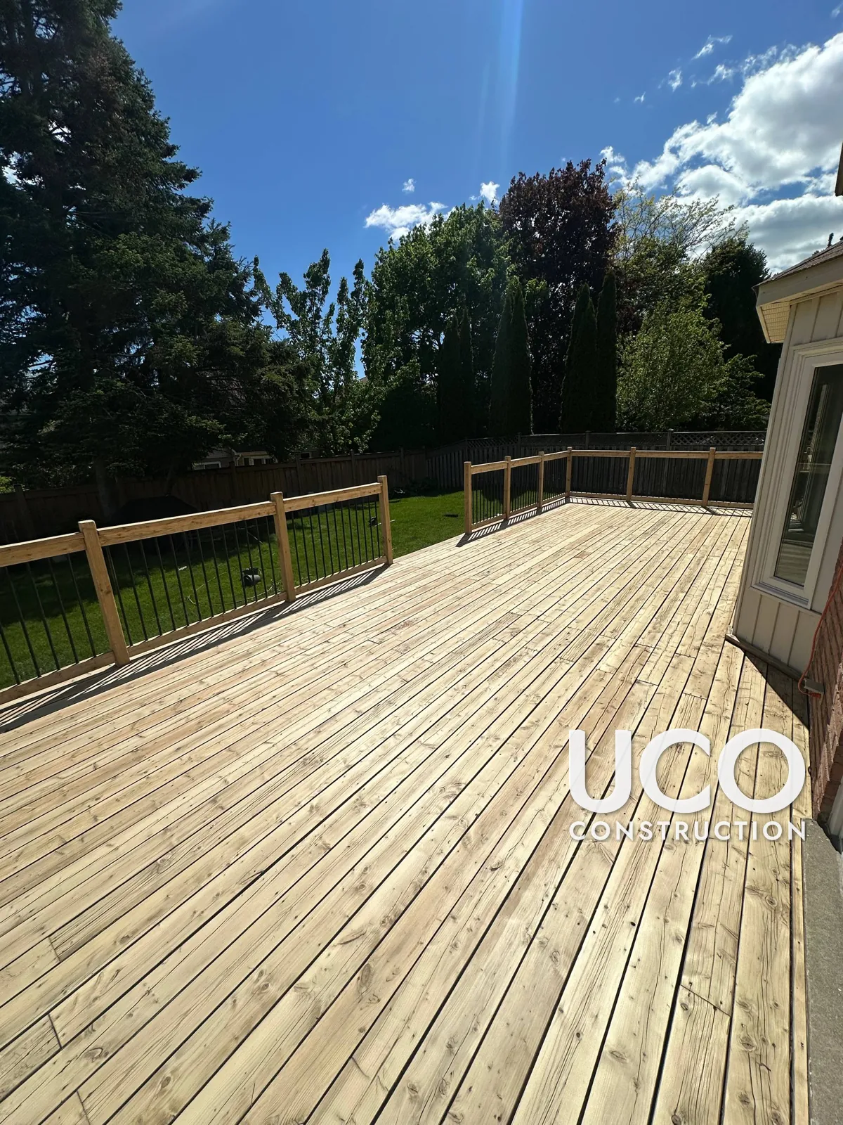 Deck Staining in Whitby: Large Deck With Peeling Tan Solid Stain Sanded to Bare Wood and Refinished in a Redwood Cedar Stain