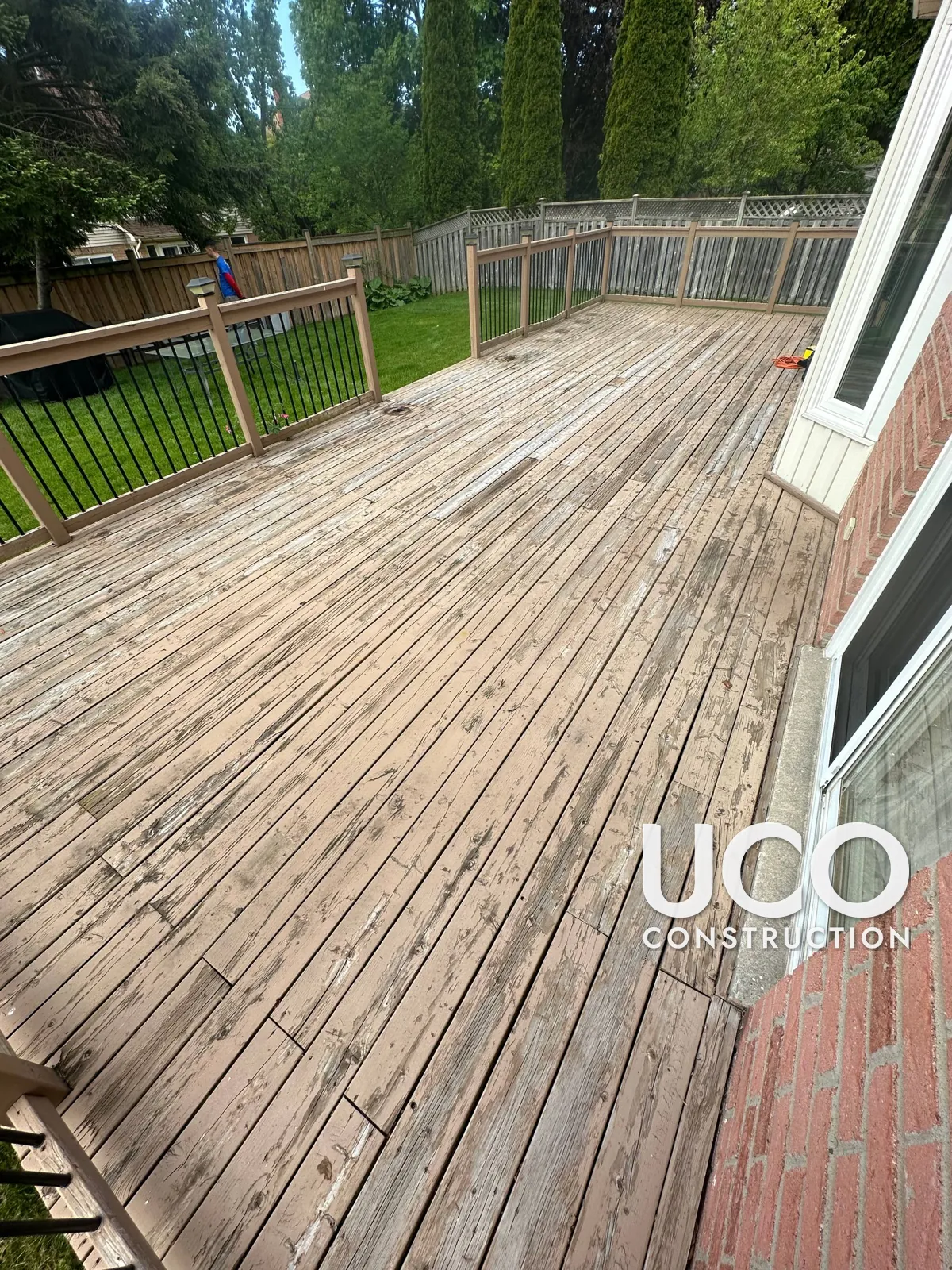Deck Staining in Whitby: Large Deck With Peeling Tan Solid Stain Sanded to Bare Wood and Refinished in a Redwood Cedar Stain