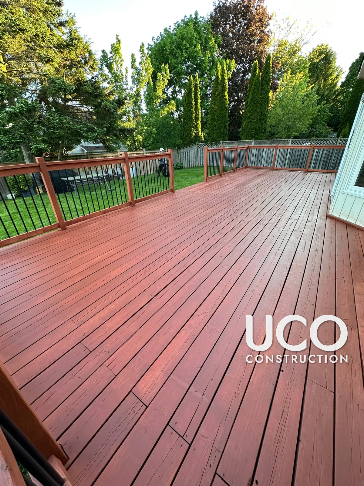 Deck Staining in Whitby: Large Deck With Peeling Tan Solid Stain Sanded to Bare Wood and Refinished in a Redwood Cedar Stain