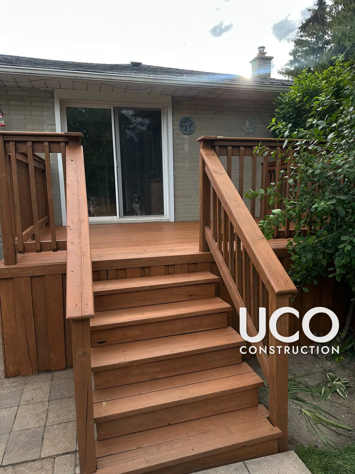 Deck Cleaning and Staining in Aurora: Grey, Mildewed Deck With Stairs, Railings and Skirting Power Washed and Refinished in a Cedar Stain