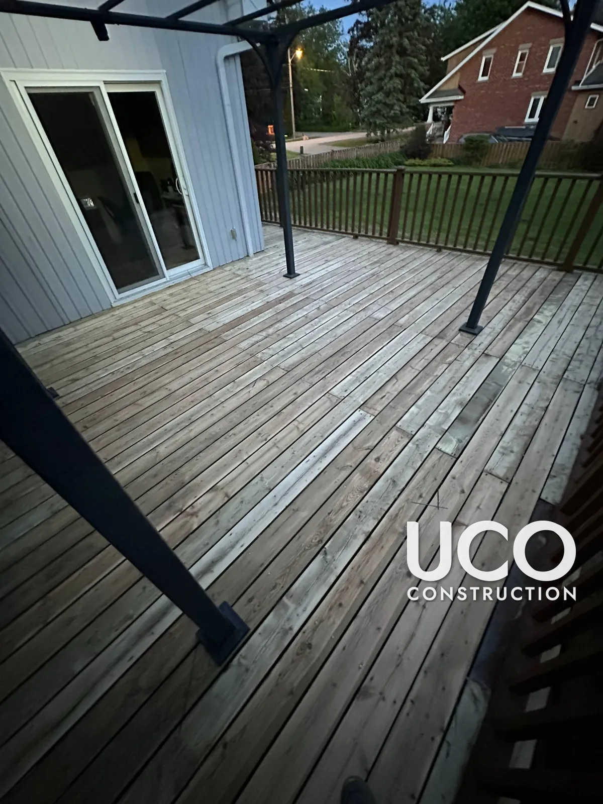 Deck Staining in Pickering: Large Deck With Peeling Grey Solid Stain Sanded to Bare Wood and Refinished in a Golden Cedar Stain, Railings Refreshed in Brown