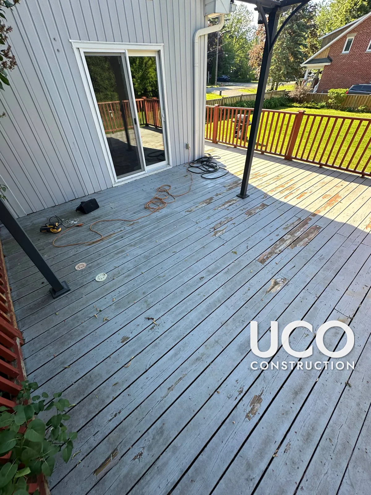 Deck Staining in Pickering: Large Deck With Peeling Grey Solid Stain Sanded to Bare Wood and Refinished in a Golden Cedar Stain, Railings Refreshed in Brown