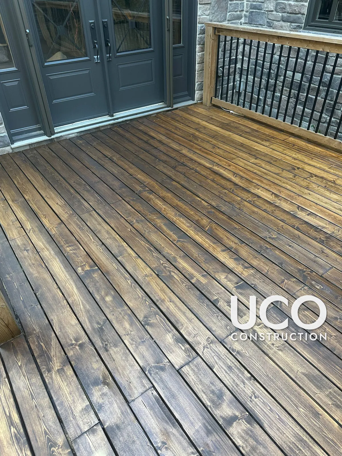 Deck Staining in Etobicoke: Peeling Dark Grey Solid Stain Sanded Off and Deck Refinished in a Rich Dark Brown Penetrating Stain
