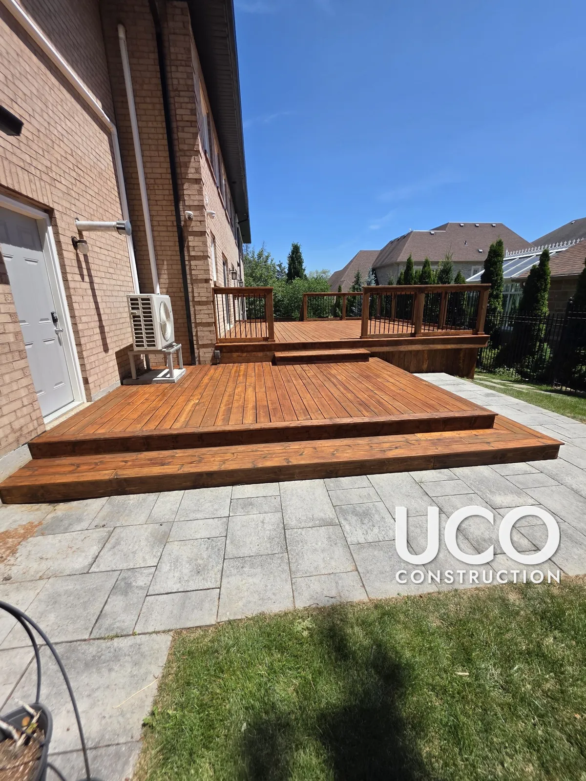 Deck Staining in Richmond Hill: Two-Level Deck With Wraparound Steps and Railings Sanded and Refinished in a Rich Cedar Stain