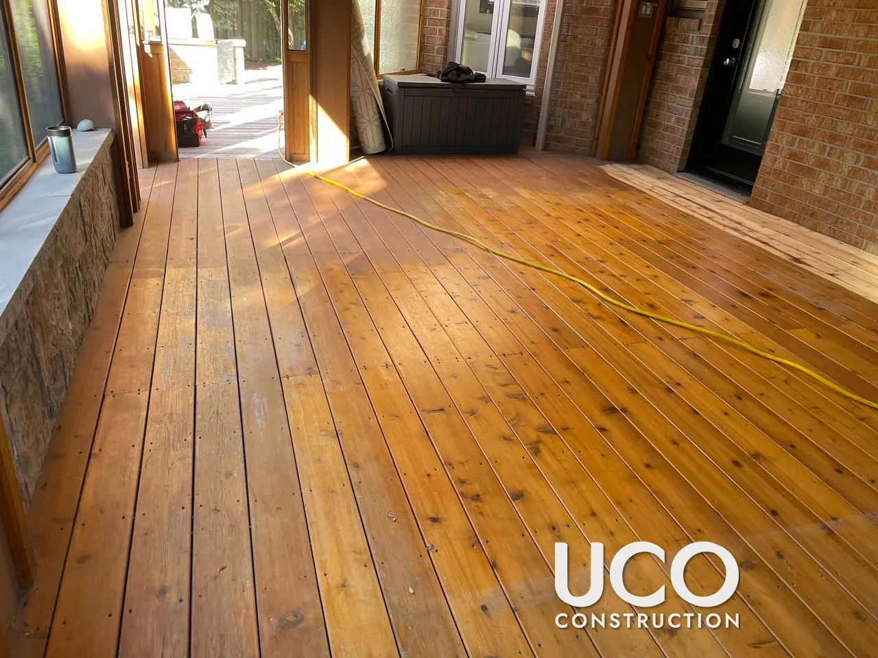Cedar Deck and Sunroom Floor Restoration in Whitby: Weathered Cedar Boards Replaced Where Needed, Sanded and Stained Under a Pergola
