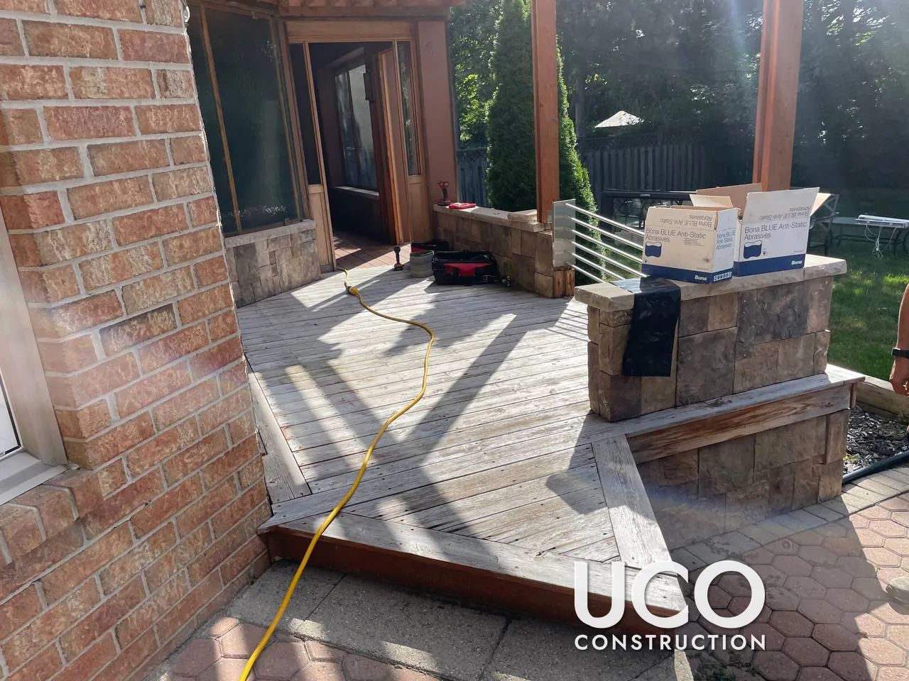 Cedar Deck and Sunroom Floor Restoration in Whitby: Weathered Cedar Boards Replaced Where Needed, Sanded and Stained Under a Pergola