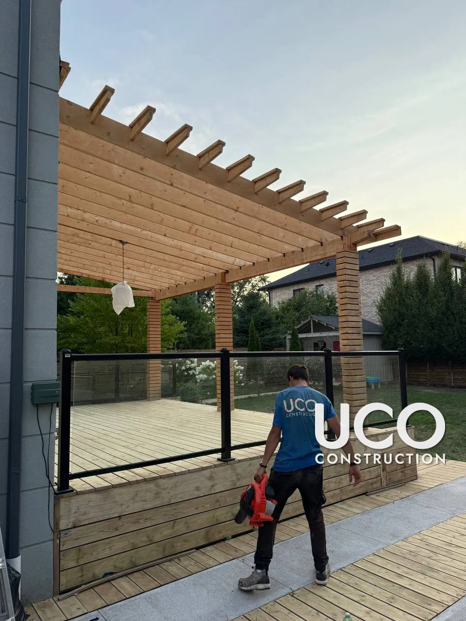 Pergola and Deck Staining in Oakville: Large Wood Pergola, Slatted Columns and Deck With Glass Railings Sanded and Refinished in a Natural Stain