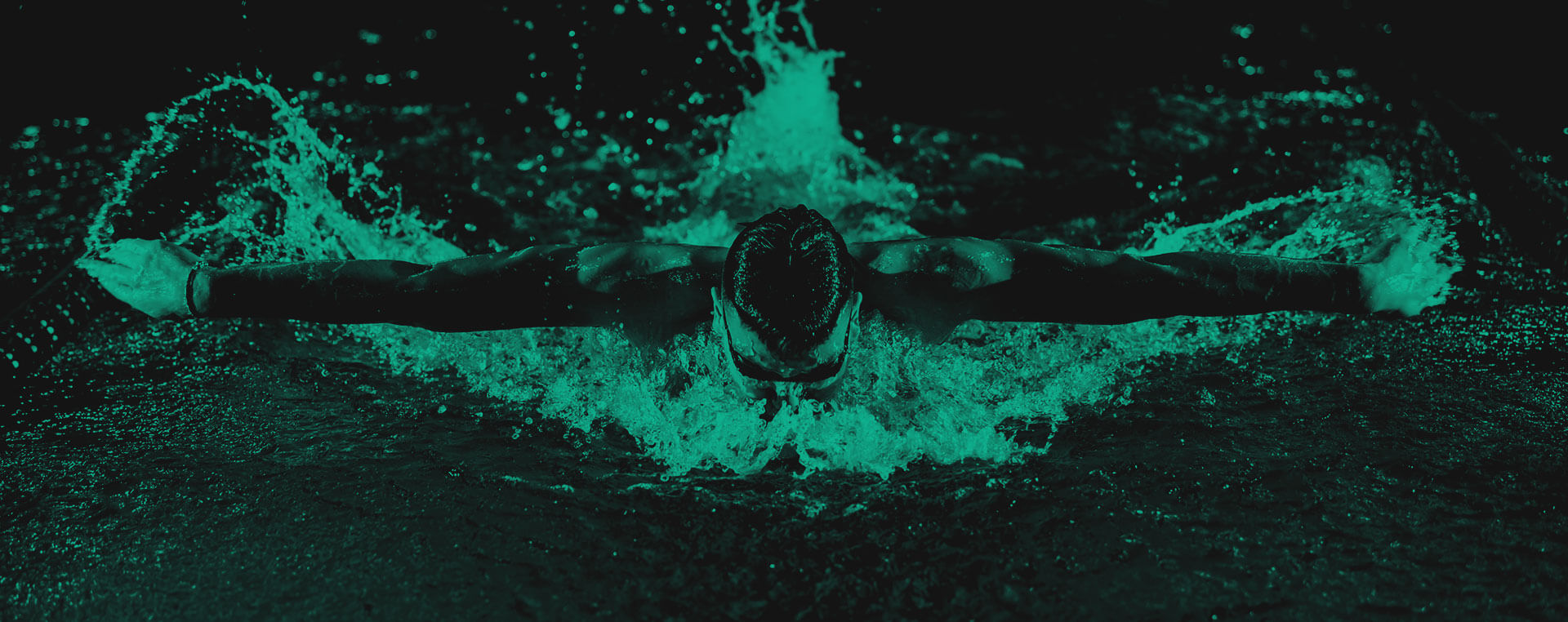 Green and black background image with a man swimming and facing the camera