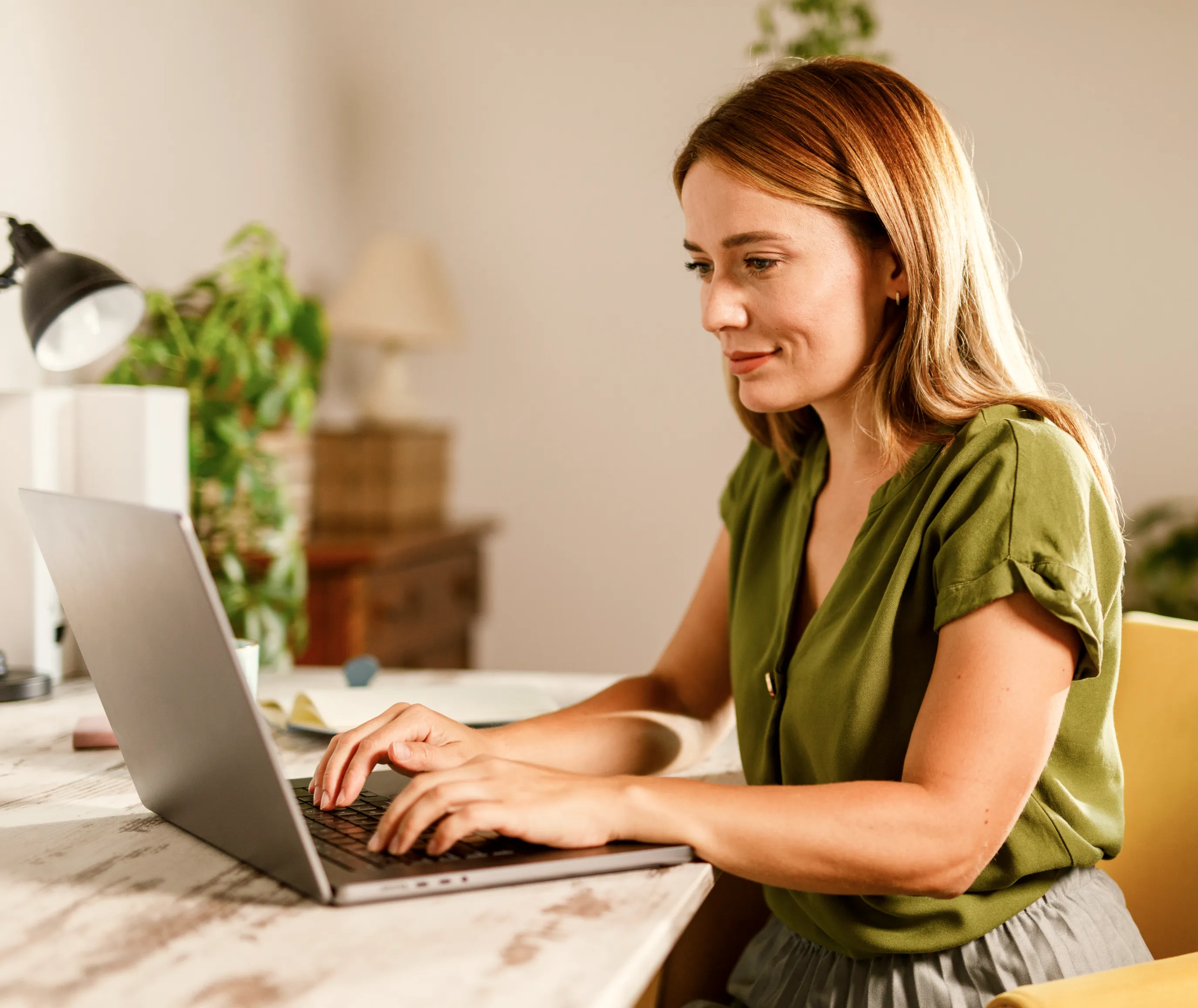a woman working in a workspace design to enhance employee wellbeing
